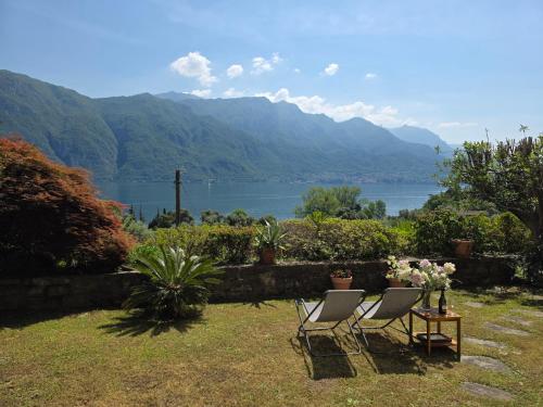 two chairs and a table with a view of a lake at Ca Maria Celeste Apartment in Bellagio