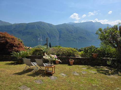 a pair of chairs and a table with a view of a lake at Ca Maria Celeste Apartment in Bellagio