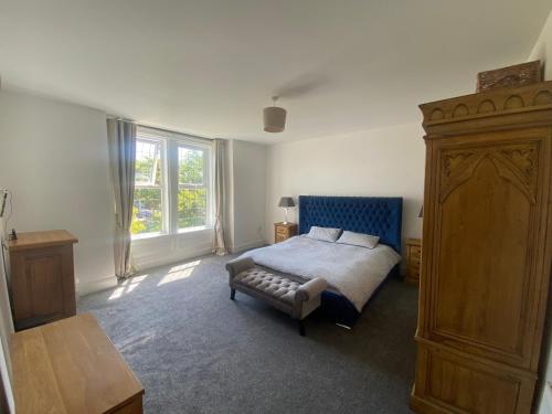 a bedroom with a bed and a large dresser at The Dales in Marshside
