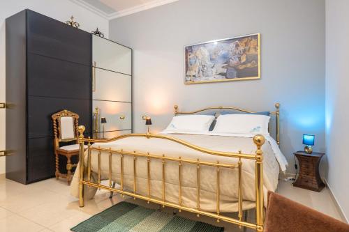 a bedroom with a large bed and a mirror at By Domy 2 Grottaglie in Grottaglie
