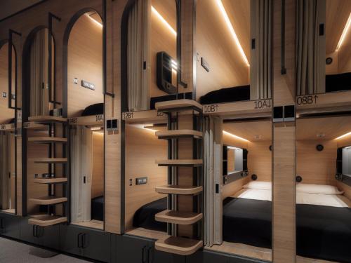 a room with four bunk beds and a staircase at GettSleep Madrid Airport T4S - Boarding Pass Required in Madrid