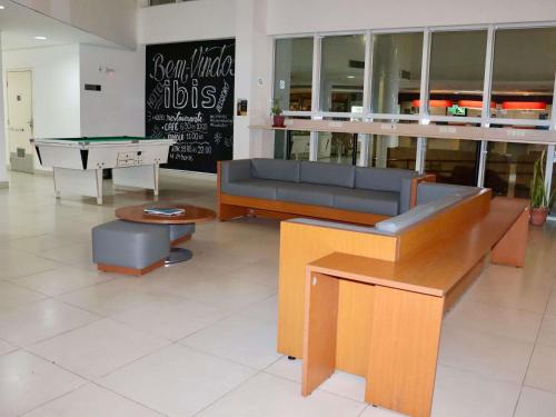 a living room with a couch and a pool table at Ibis Mossoro in Mossoró