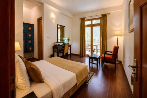 a bedroom with a bed and a desk and a table at The Apricot Tree Hotel in Nūrla
