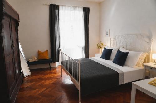 a bedroom with a bed and a large window at TT Apartmani - Historic Center Pula in Pula