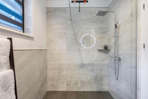 a shower with a glass door in a bathroom at Schmidtsches Quartier in Oybin
