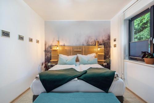 a bedroom with a large bed and a window at Schmidtsches Quartier in Oybin