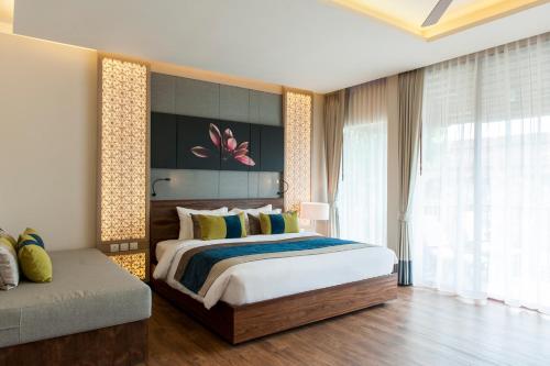 a bedroom with a large bed and a large window at Chaweng Regent Beach Resort in Chaweng