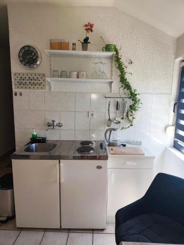 a small kitchen with a sink and a counter at Casa Nostra II - Sunny Holiday Stay Near the Beach in Funtana
