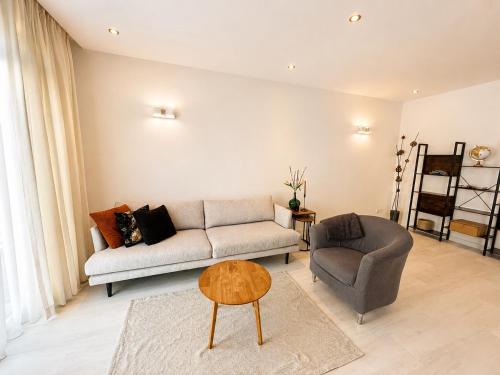 a living room with a couch and a chair at Gateway to Amsterdam in Almere