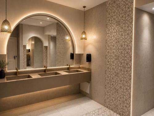a bathroom with two sinks and a mirror at Zodiac Hôtel & Aqua Park in Hammamet