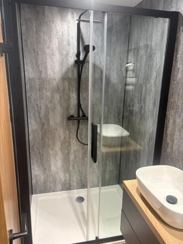 a shower with a glass door in a bathroom at Strathmore Guest house in Fort William