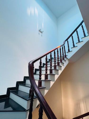 a staircase with black and white steps and a blue ceiling at Nhà nghỉ B48 in Cù Lao Tâu