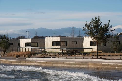 a building next to a body of water at Lost Shore Surf Resort in Ratho