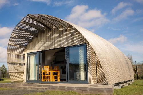 a dome shaped building with chairs inside of it at Lost Shore Surf Resort in Ratho