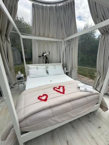 a bedroom with a bed with two hearts on it at Glamping & Spa Luna Azzurra in Sulmona