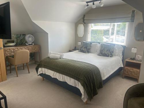 a bedroom with a bed and a desk and a television at Wendys house in Sarisbury Green