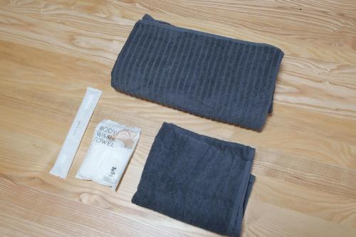 two pieces of cloth sitting on top of a wooden floor at 民泊ａｉｋｏ in Fukushima