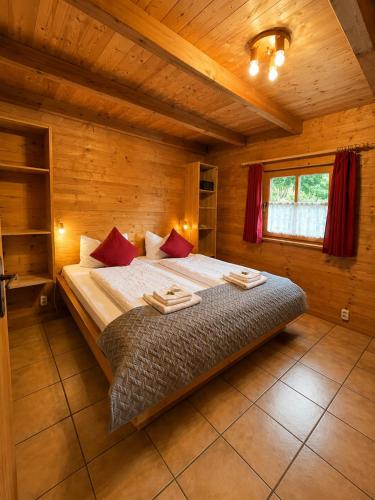 a bedroom with a large bed in a wooden room at Chalets mit Schlierseeblick, neue Küche neues Bad in Schliersee