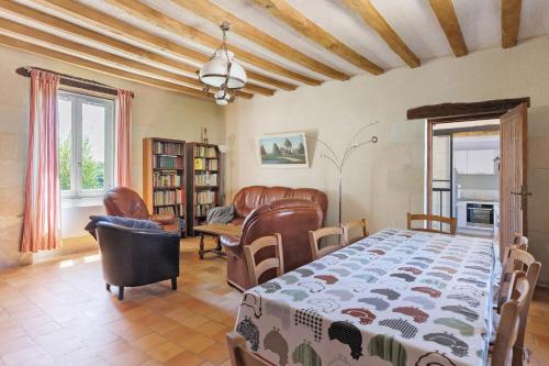a bedroom with a bed and a living room at Le Vallon in Mondion
