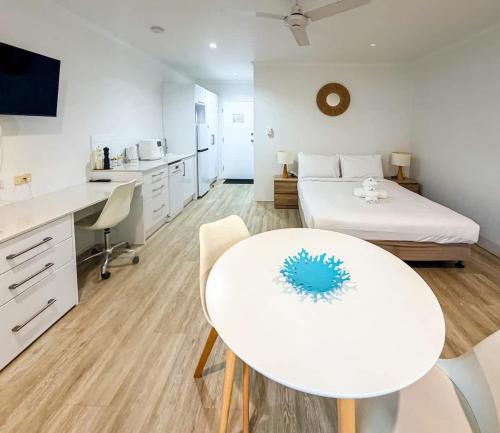 a room with a bed and a white table and chairs at U222 - The Serenity in Eimeo