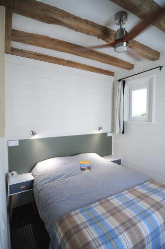 a bedroom with a bed and a window at Le Petit Musée in Loches
