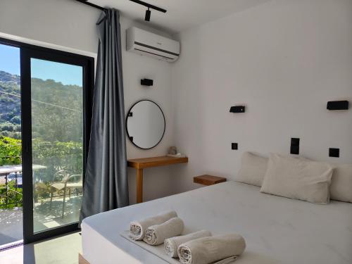 a bedroom with a large bed with towels on it at Galini Studios & Apartments-Adults only in Sougia