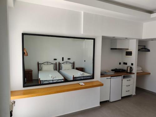 a bedroom with a large mirror on the wall at Galini Studios & Apartments-Adults only in Sougia