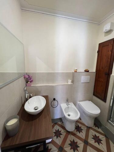 a bathroom with a sink and a toilet at La Terrazza Sul Monte in Monte San Savino