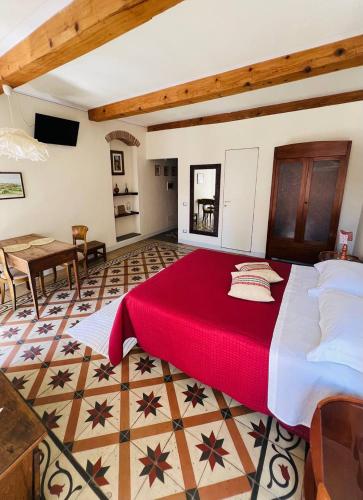 a bedroom with a large bed with a red blanket at La Terrazza Sul Monte in Monte San Savino