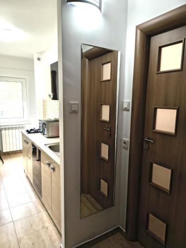 a door leading into a kitchen with a kitchen counter at Gamma Group Sud in Bucharest