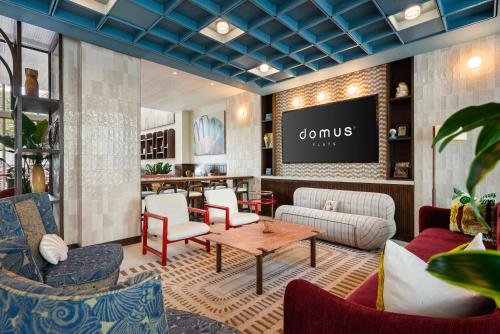 a lobby with a waiting area with chairs and a table at Domus Brickell Park in Miami