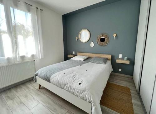 a bedroom with a large bed with a mirror on the wall at Maison familiale dans le var in Brignoles
