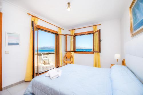a bedroom with a bed and a view of the ocean at Can Figó in Alcudia
