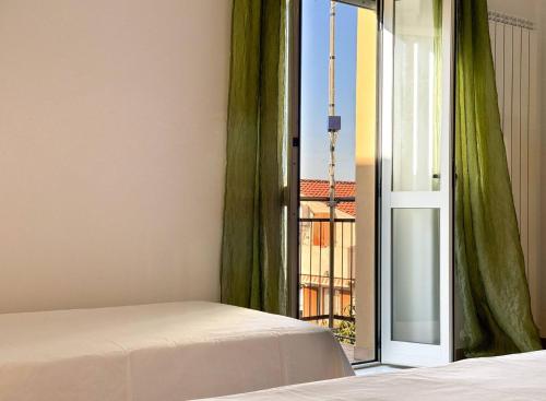 a bedroom with a bed and an open window at Dimora Fonte Grande in Lanciano
