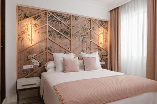 a bedroom with a large bed with a wooden wall at Blue Marina Suites - Boutique Apartments in Arrecife