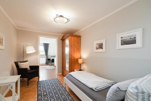a bedroom with a bed and a desk and a chair at Wieschengrund in Neustadt in Holstein