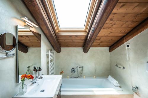 a bathroom with a white tub and a sink at Ca' Del Monastero 9 Collection Spacious Apartment up to 5 Guests in Venice
