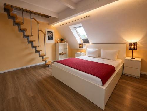a bedroom with a bed with a staircase in it at Chalet Platzhirsch in Braunlage