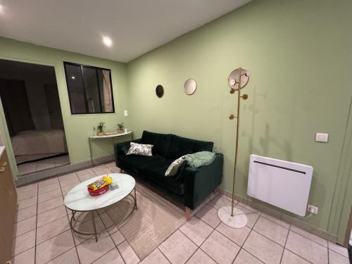 a living room with a couch and a table at Appartement hyper centre de Mons in Mons