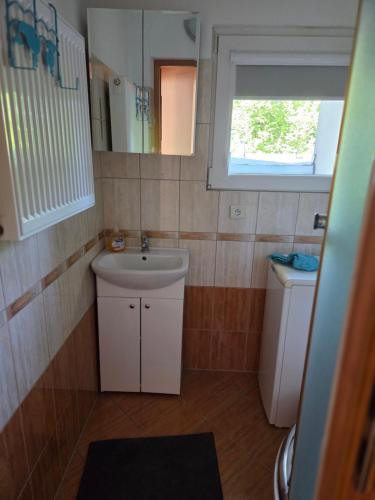 a small bathroom with a sink and a toilet at Apartament blisko Świeradowa in Mirsk