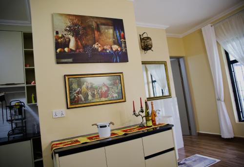 a living room with a painting on the wall at Shamba la Chini in Nairobi