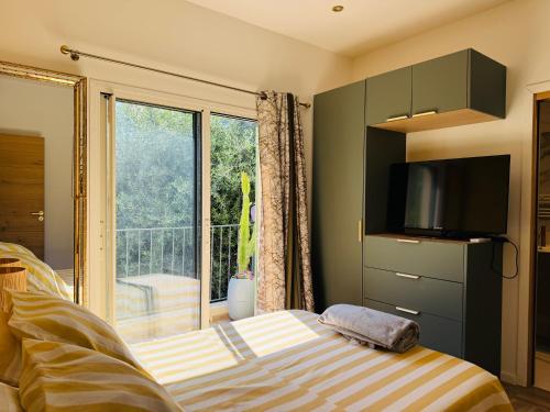 a bedroom with a bed and a large window at CANNES Maison Design "DOLCE VITA" in Cannes