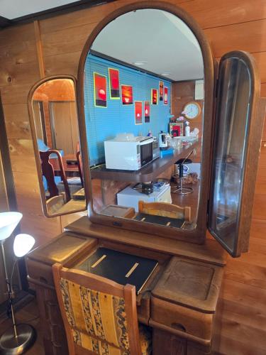 a mirror on a table with a counter in a room at Super Henro Inn in Nahari