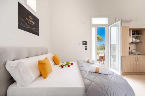 a living room with a white couch with yellow pillows at Almària - Rooms e Garden in Nardò
