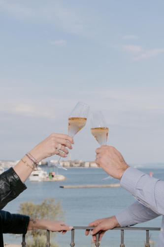 two people holding up glasses of wine at Hotel Niko in Zadar