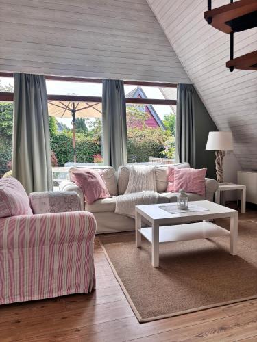 a living room with a couch and a table at Ferienhaus Wittensee in Bünsdorf
