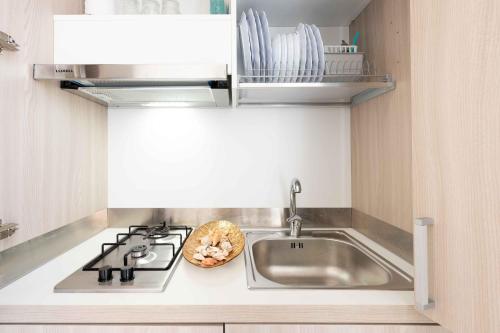 a kitchen counter with a sink and a stove at Monolocale Aurea 5 in Nardò
