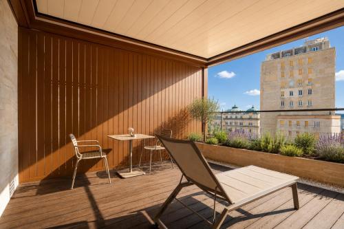 a patio with a table and chairs on a balcony at Boutique Hotel OPERA in Rijeka