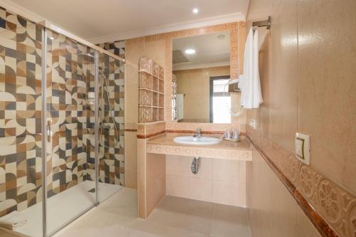 a bathroom with a sink and a shower at Hotel Pozo del Duque in Zahara de los Atunes