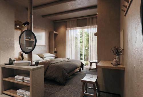 a bedroom with a bed and a mirror and a sink at Nordic Vida Hotel in Cuxhaven